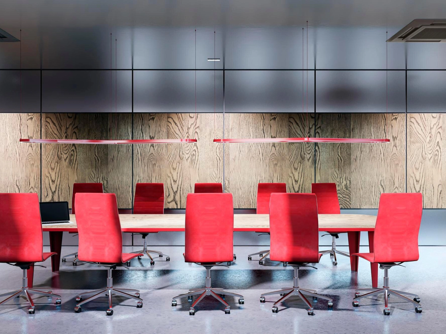 Una sala riunioni moderna con un lungo tavolo e sedie rosse, alle pareti pannelli in legno